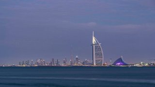 The Dubai skyline features iconic skyscrapers including the Burj Al Arab, viewed against a tranquil sea backdrop | MSC Cruises