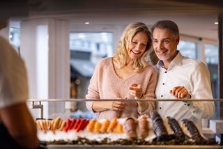 A couple enjoys selecting fresh seafood together at the La Pescaderia restaurant onboard MSC World Europa | MSC Cruises