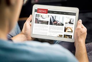 A man using a tablet to explore internet packages while enjoying life on board | MSC Cruises