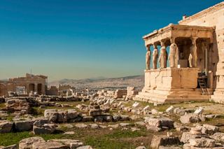 The Erechtheion stands proudly on the Acropolis, surrounded by ancient ruins under a clear blue sky | MSC Cruises