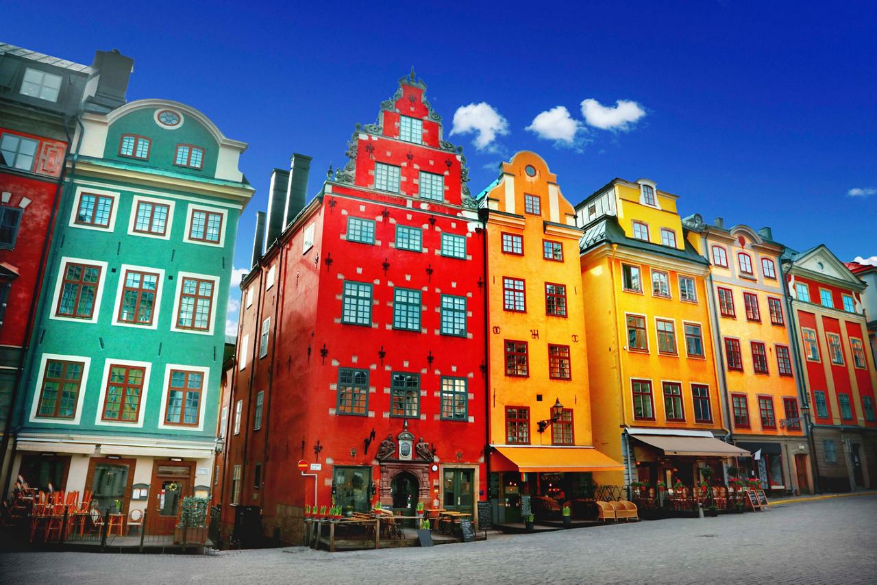 Vibrant buildings in various colours line the street, showcasing Stockholm's charming architecture | MSC Cruises