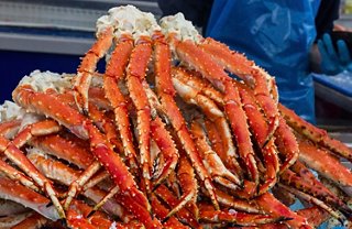 Freshly caught crabs displayed at a bustling market in Bergen, Norway, inviting culinary exploration and enjoyment | MSC Cruises