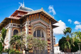 The beautiful exterior of the Schoelcher Library in Fort-de-France, surrounded by lush greenery and blue skies | MSC Cruises