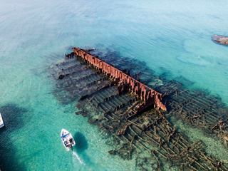 Aerial view of a shipwreck beneath clear turquoise waters in Bermuda | MSC Cruises
