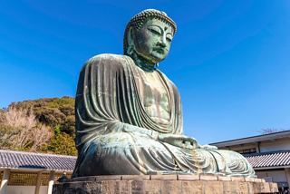 The Great Buddha statue in Kamakura, Japan, stands majestically against a clear blue sky | MSC Cruises