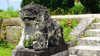 A stone guardian sculpture nestled among vibrant greenery in Fushiki, Japan | MSC Cruises