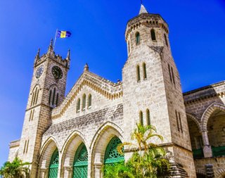 The iconic Parliament Buildings in Bridgetown, Barbados, surrounded by lush greenery and a clear blue sky | MSC Cruises