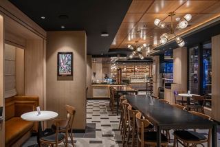 A stylish bar area featuring warm tones, elegant furnishings, and a welcoming atmosphere | MSC Cruises