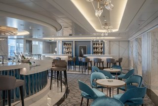 A stylish bar area featuring elegant seating and a modern bar counter designed for relaxation and socialising | MSC Cruises