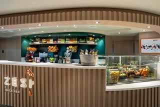 A vibrant juice bar featuring a sleek counter and fresh fruit displays, inviting guests to enjoy refreshing beverages | MSC Cruises