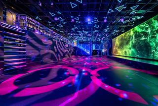 Vibrant lighting and colourful designs create an exciting atmosphere in the MSC Luna Park Arena entertainment area | MSC Cruises