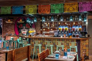 A vibrant dining area featuring a taco counter, colourful decor, and inviting seating for guests | MSC Cruises