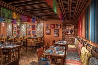 Vibrant dining space featuring tables and chairs adorned with festive decorations | MSC Cruises