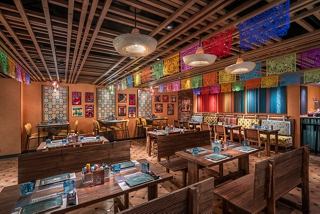 A vibrant dining area with colourful decorations, inviting guests to enjoy a unique culinary experience | MSC Cruises