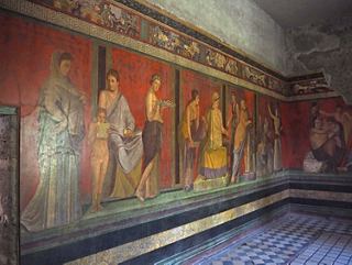 A vibrant fresco depicting figures from ancient times on a wall in an archaeological site in Pompeii | MSC Cruises