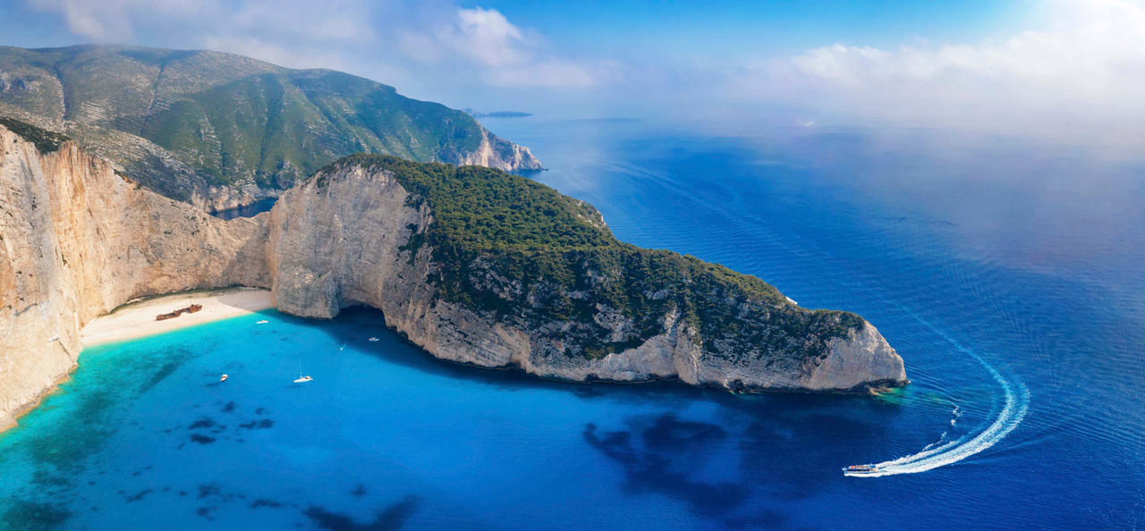 Aerial view of Zakynthos coastline featuring turquoise waters and the famous Navagio Beach cove | MSC Cruises