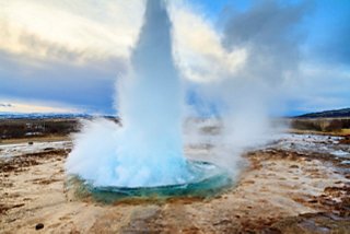 Strokkur geyser erupts in Iceland's stunning landscape, showcasing nature's power and beauty | MSC Cruises