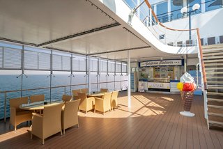 A welcoming outdoor seating area with chairs and tables, perfect for enjoying the sea breeze | MSC Cruises