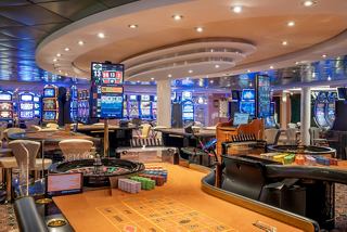 A vibrant casino area on MSC Lirica, featuring gaming tables and slot machines for entertainment | MSC Cruises