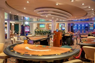 A vibrant casino area onboard MSC Lirica with gaming tables and slot machines inviting guests to enjoy thrilling entertainment | MSC Cruises