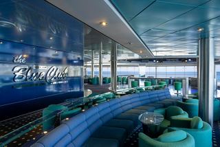 A vibrant lounge area featuring seating and a bar in The Blue Club Disco on MSC Lirica | MSC Cruises