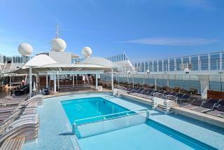 A serene pool area onboard MSC Lirica, inviting relaxation and enjoyment under the sun | MSC Cruises