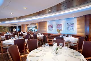A warm and inviting dining area with elegantly set tables and comfortable seating for guests | MSC Cruises