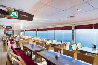 A welcoming dining area with tables and seating, offering stunning sea views from the MSC Lirica restaurant | MSC Cruises