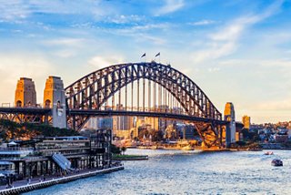 The Sydney Harbour Bridge stands majestically against a sunset sky, symbolising adventure in Australia | MSC Cruises