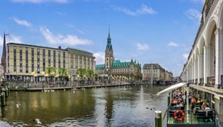 A scenic view of Hamburg's City Hall alongside the Alster River, capturing the essence of this vibrant destination | MSC Cruises