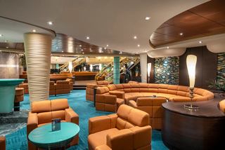 A welcoming lounge area featuring comfortable sofas and armchairs, perfect for relaxing with friends | MSC Cruises