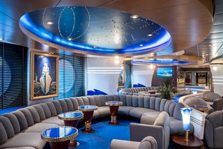 A stylish lounge area with comfortable seating and a vibrant blue decor, perfect for relaxation and socialising | MSC Cruises