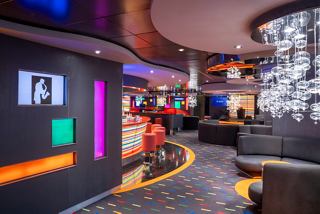 The inviting Manhattan Bar on MSC Fantasia features stylish seating and a vibrant atmosphere for relaxation and enjoyment | MSC Cruises