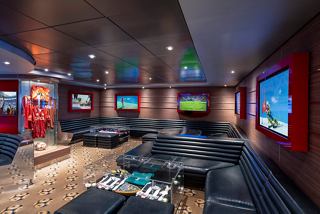 A stylish sports bar with comfortable seating and screens for an enjoyable social experience | MSC Cruises