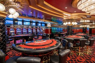 A vibrant casino area with gaming tables and slot machines inviting guests to enjoy thrilling entertainment | MSC Cruises
