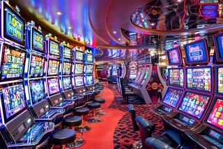 A vibrant casino scene with numerous slot machines and comfortable seating inviting guests to enjoy entertainment | MSC Cruises