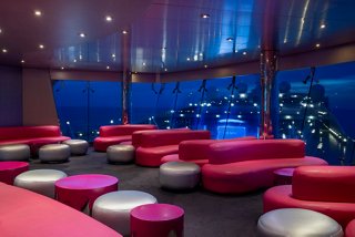 A vibrant lounge area with stylish seating and a captivating sea view, perfect for relaxing and socialising | MSC Cruises
