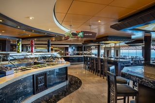 A welcoming dining area featuring a buffet setup with tables, chairs, and views of the sea | MSC Cruises