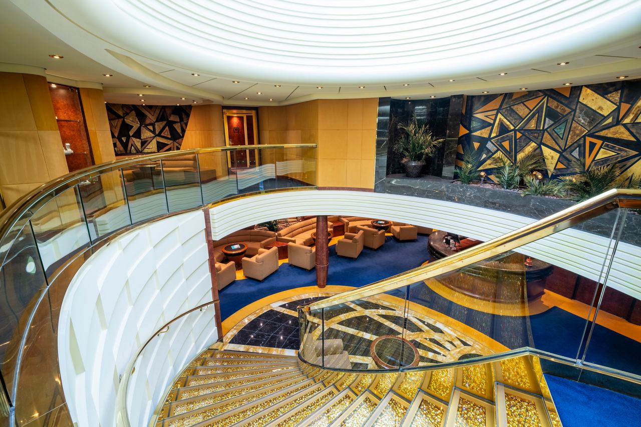 Ein einladender Concierge-Bereich im MSC Yacht Club an Bord der MSC Fantasia mit bequemen Sitzgelegenheiten und eleganter Dekoration | MSC Cruises