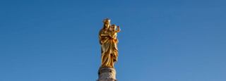 Golden statue against a blue sky, symbolizing hope and inspiration | MSC Cruises