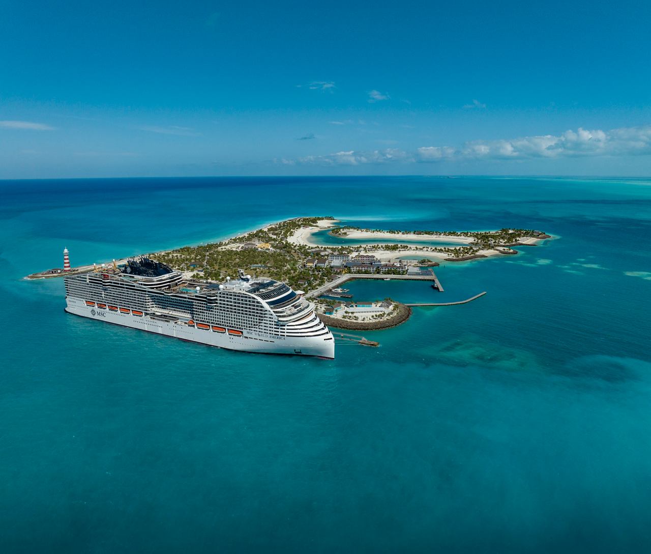 Vue aérienne du MSC World America amarré à Ocean Cay, mettant en valeur des plages de sable et une végétation luxuriante | MSC Cruises