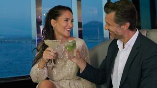 A couple enjoys cocktails together at dusk in the stylish Black & White Lounge with stunning ocean views | MSC Cruises