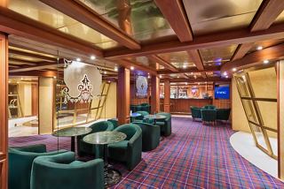 An inviting lounge area featuring comfortable seating and a vibrant atmosphere for relaxation and socialising | MSC Cruises