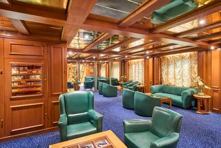A stylish lounge area with comfortable seating and warm wooden decor for relaxation and socialising | MSC Cruises