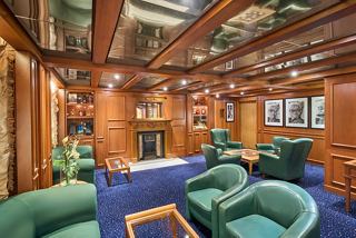 A warm and inviting lounge area featuring comfortable seating and elegant decor, perfect for relaxation and socialising | MSC Cruises