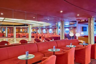 A vibrant bar area with comfortable seating, inviting guests to relax and enjoy refreshments | MSC Cruises
