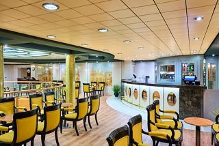 A welcoming bar area with yellow chairs, tables, and a piano, inviting guests to relax and enjoy | MSC Cruises