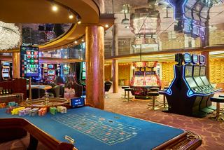 Public area in Palm Beach Casino on MSC Armonia ship with slot machines and roulette | MSC Cruises