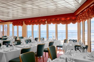 A stylish restaurant with elegant seating and panoramic sea views invites guests to enjoy exquisite dining experiences | MSC Cruises