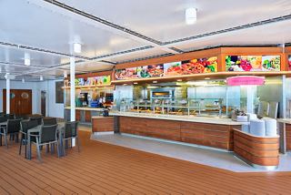 A welcoming dining area featuring a service counter with a variety of food options and seating for guests | MSC Cruises